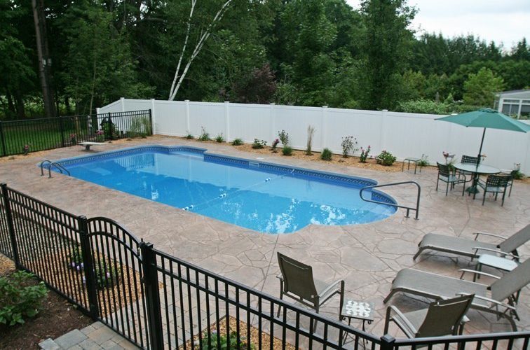 This is a photo of a patrician in ground pool with custom pool house.