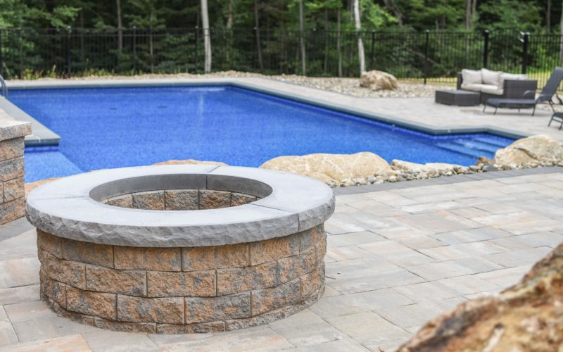 Custom inground pool with fire place installed by Majestic Pools