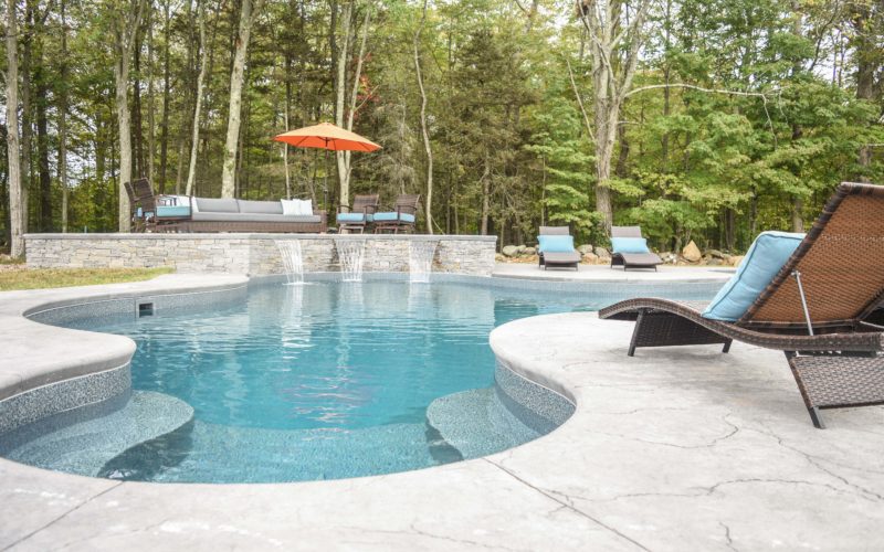 Custom inground pool with waterfall installed by Majestic Pools